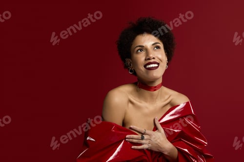 Preview: Young beautiful woman radiates elegance in striking red attire against a vibrant backdrop