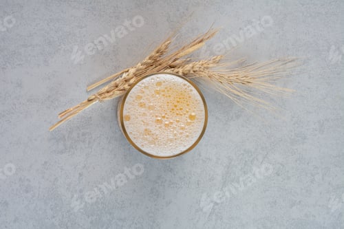 Preview: A glass of beer with wheat on white background