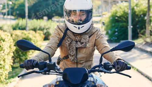 Preview: Biker riding motorcycle wearing helmet and leather jacket in city park