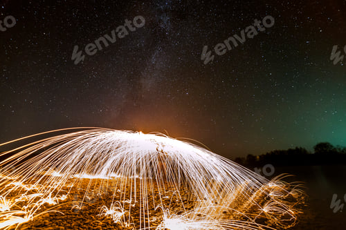 Preview: Light painting art concept. Spinning steel wool in abstract circle