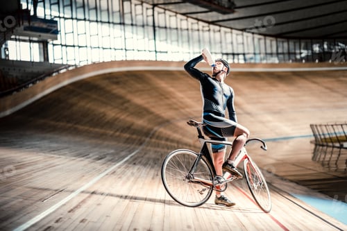 Male Cyclist Drinking Water on Velodrome Track