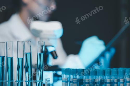 Preview: biochemical research scientist working with microscope for coronavirus vaccine development in, Portr