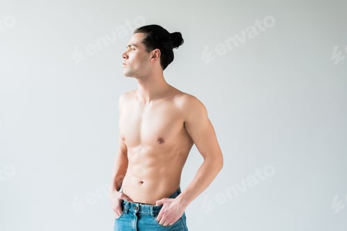 Preview: handsome shirtless man standing with hands in pockets on white
