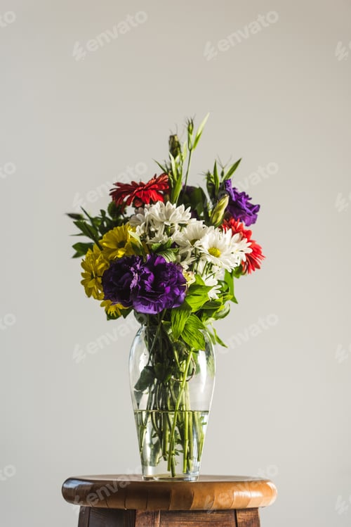 Preview: bouquet of colorful flowers in glass vase, isolated on grey