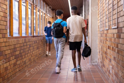 Preview: Walking in school hallway, two boys with backpacks heading to class