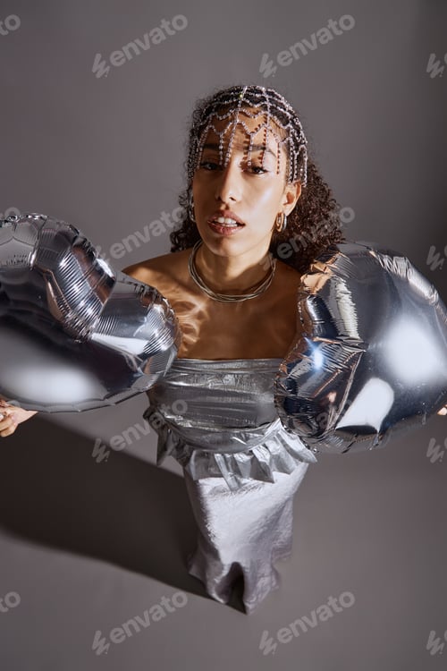 Preview: Portrait of Young Woman Posing with Metallic Balloons