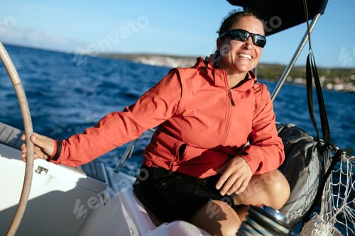 Preview: Attractive strong woman sailing with her boat