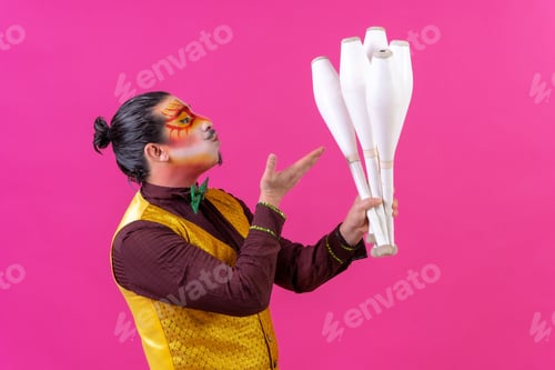 Preview: Cheerful circus performer holding a number of clubs isolated on pink background