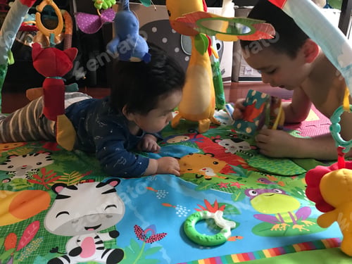Preview: Children Playing with Toys on a Colorful Mat