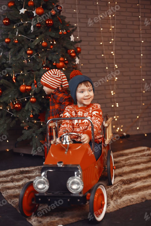 Preview: Cutte little kids at home near christmas decorations