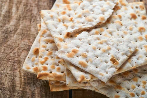 Preview: Matzah. Traditional ritual Jewish bread on old wooden rustic background. Passover food. Pesach Jewis