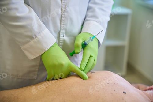 Preview: Doctor examines the injection site on the patient body
