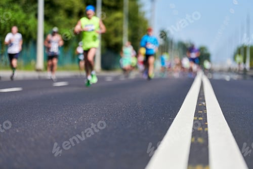 Preview: Runners on city road.