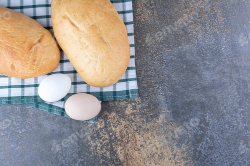 Preview: Buns and eggs displayed on a towel on marble background