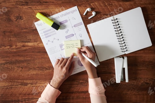 Preview: Business Person Writing on Sticky Notes