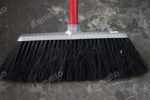 Preview: High angle shot of a cleaning brush on a gray floor