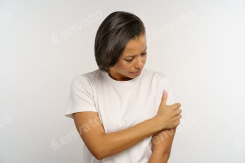 Preview: Pain in arm: sick woman pressing injured shoulder to body scared of bone fracture suffer from ache