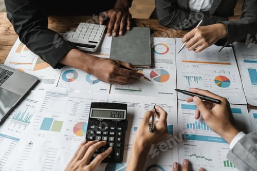 Preview: Team Examining Charts and Graphs in Modern Office