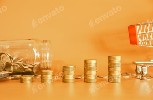 Preview: Stack of golden money coin on yellow background with small shopping cart and coin bottle