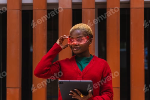 Preview: Young black woman wearing augmented reality cyber glasses