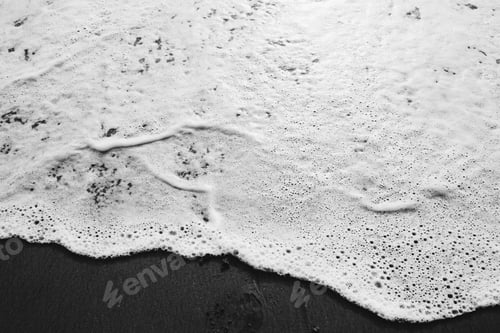 Preview: White Sea Foam on Dark Beach Sand