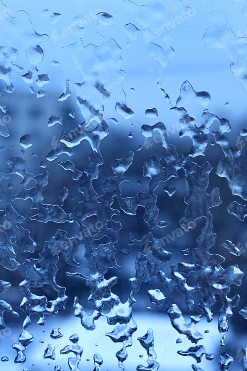 Preview: Frozen water drops on the winter glass