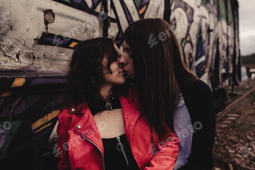 Preview: Long haired man hugging and kissing woman near train