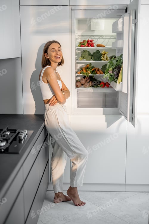 Preview: Woman with healthy vegetables in the fridge