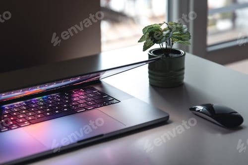 Preview: Close up of laptop keyboard colorful neon illumination, backlit keyboard.