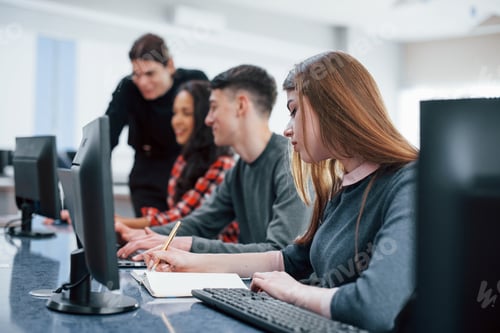Preview: Everyone doing his work. Group of young people in casual clothes in the modern office