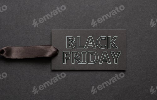 Preview: Black Friday sale, text on a paper price tag on black