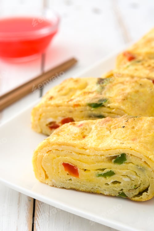 Preview: Tamagoyaki, japanese rolled omelette with chopsticks and dipping sauce
