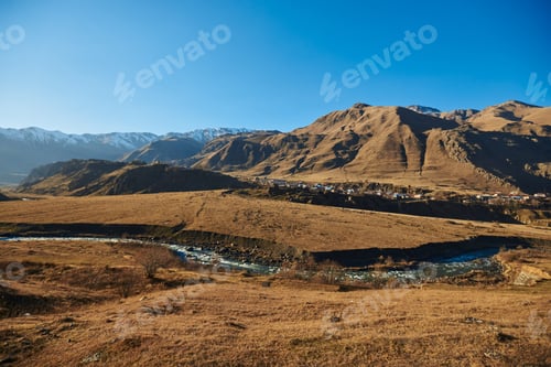 Preview: Serene brown hills meet the deep blue sky, forming a picturesque panorama.