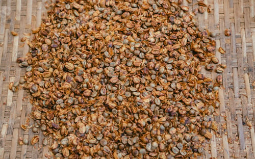 Preview: pile of coffee beans on wooden table