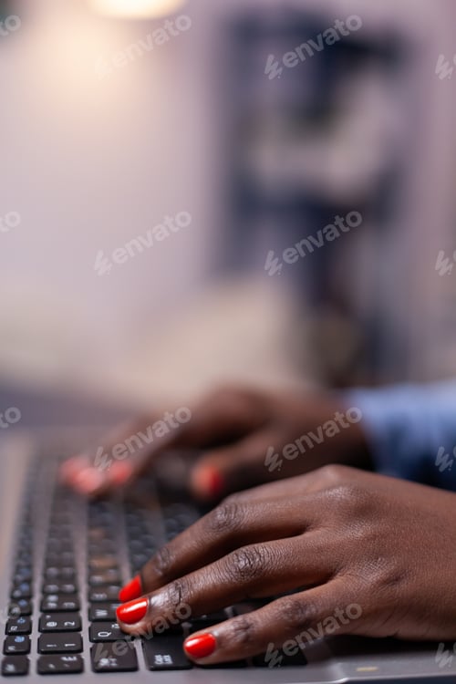 Preview: African american in living room using laptop computer
