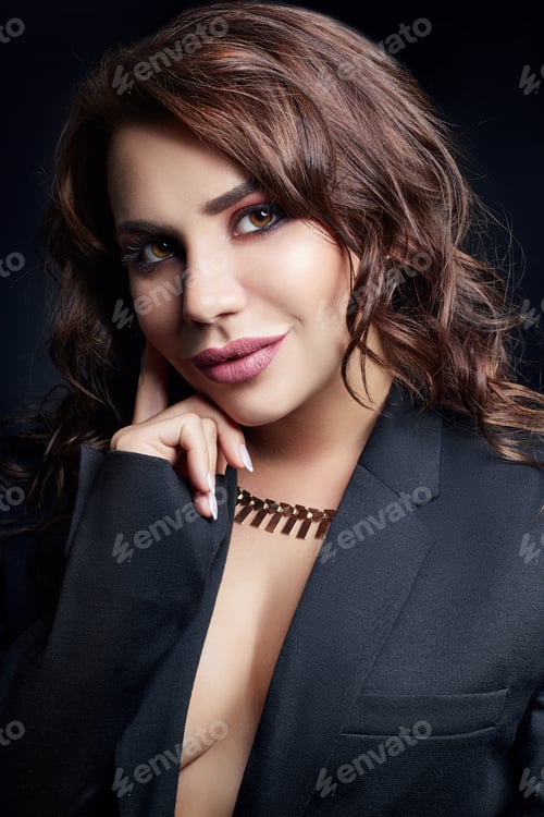 Preview: Sexy brunette with beautiful curly hair in an erotic black jacket. Expensive jewelry and smooth