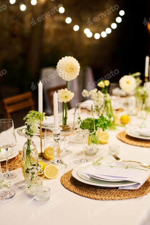 Preview: Part of table prepared for wedding party decorated with candles and flowers