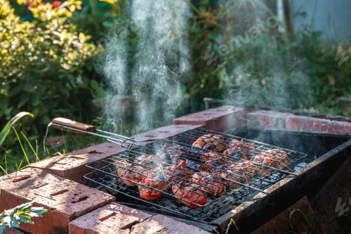 Preview: golden brown grilled chicken meat is cooked on the grill outdoors