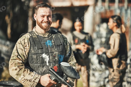 Preview: Paintball game, portrait and happy man in battlefield, challenge or military mission, gun fight or