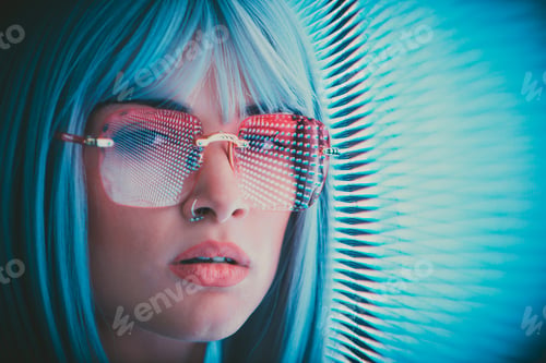 Preview: Image of a beautiful young woman posing against a led panel.