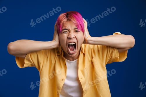 Preview: Asian boy with pink hair screaming while holding his head