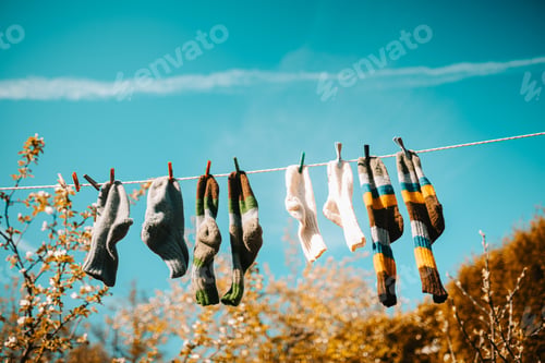 Preview: Low angle shot of socks hang on rope grafted with a clothespin