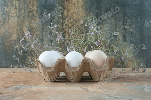 Preview: Cardboard box with chicken fresh white eggs on marble background