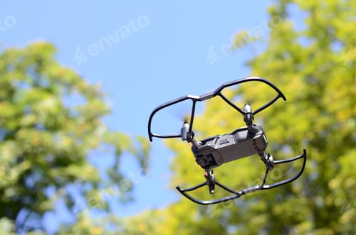 Preview: Drone with photocamera take off from land and flying for take aerial photo