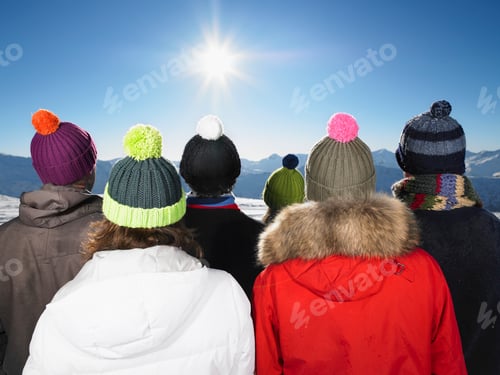 Preview: Friends gazing at a mountain vista in winter wearing colorful beanies.