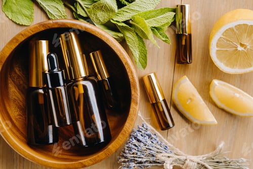 Preview: Essential oil in bottles with the aroma of lemon, mint and lavender, lying on a wooden surface