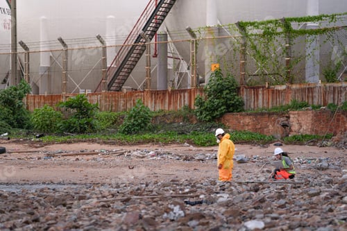 Preview: Two environmental researchers walk back from shoreline testing.