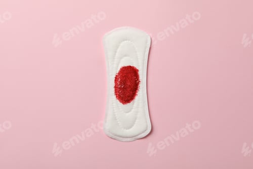 Preview: Used sanitary pad on pink background, space for text