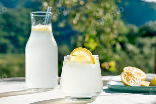 Preview: Summer refreshing lemonade drink or alcoholic cocktail with ice, rosemary and lemon slices