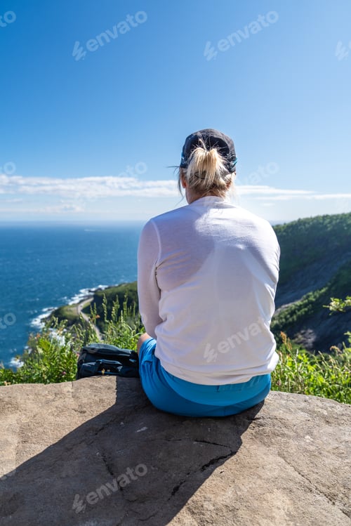 Preview: Unrecognizable woman enjoying view from mountains summer. Happy hiker traveler enjoy the view